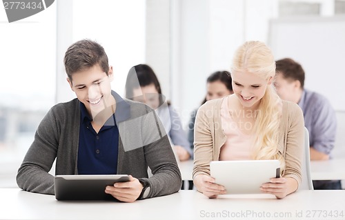 Image of students looking at tablet pc in lecture at school