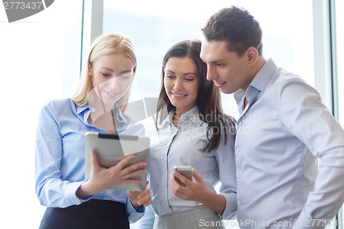 Image of business team working with tablet pcs in office