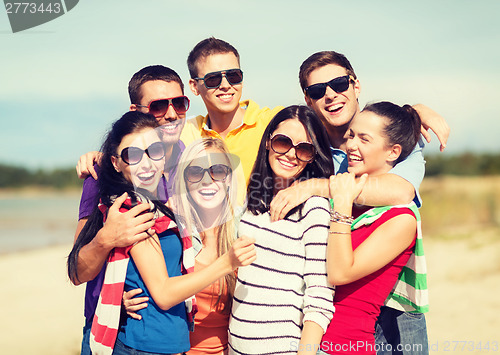 Image of group of friends having fun on the beach