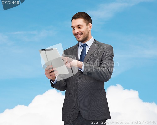 Image of smiling businessman with tablet pc computer