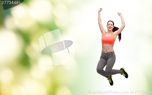 Image of sporty teenage girl jumping in sportswear