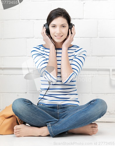 Image of happy teenage girl in big headphones