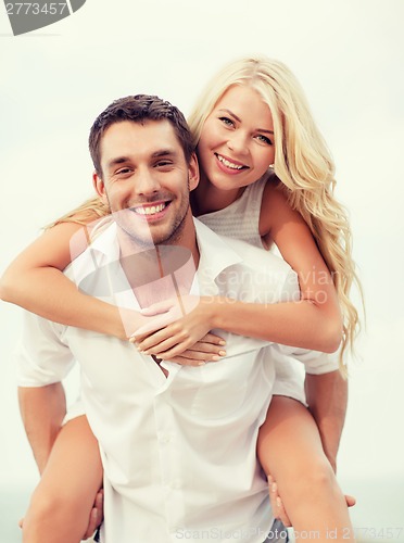 Image of couple having fun on the beach
