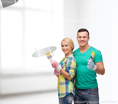 Image of smiling couple with paintbrush