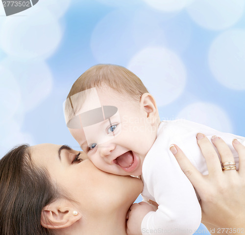 Image of laughing baby playing with mother