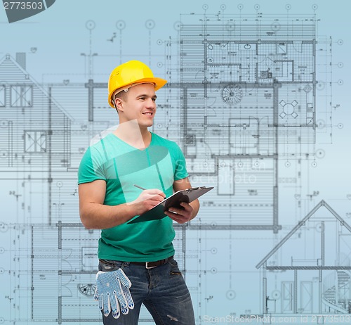 Image of smiling man in helmet with clipboard