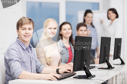 Image of students with computer monitor at school