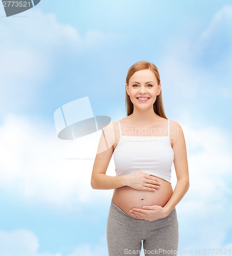 Image of happy future mother touching her belly