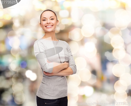 Image of smiling asian woman over with crossed arms