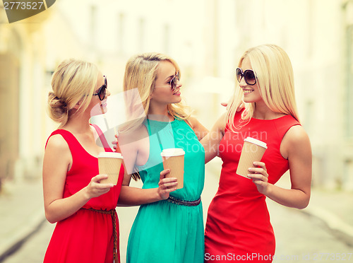 Image of women with takeaway coffee cups in the city