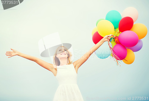 Image of woman with colorful balloons outside