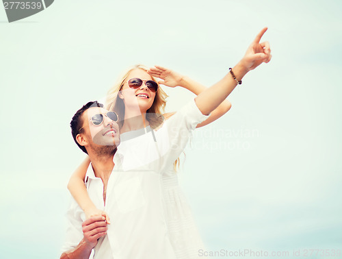 Image of couple in shades at sea side