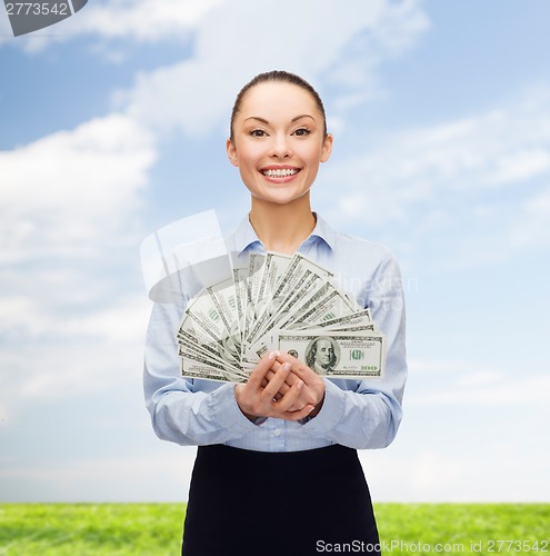 Image of young businesswoman with dollar cash money