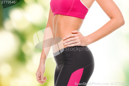 Image of close up of female abs in sportswear