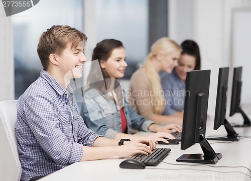 Image of students looking at computer monitor at school