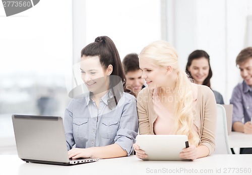 Image of students with laptop, tablet pc and notebooks