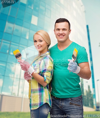 Image of smiling couple with paintbrush