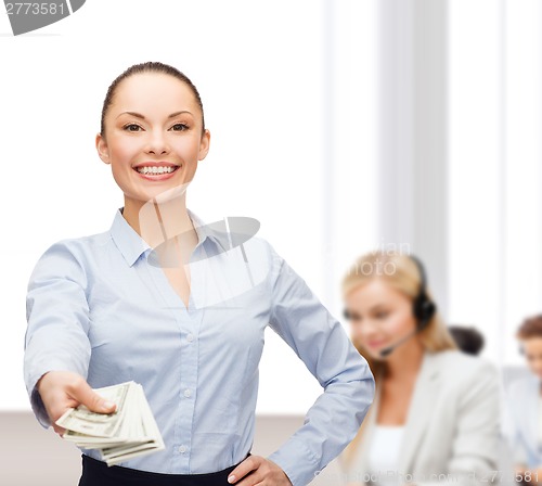 Image of young businesswoman with dollar cash money