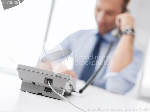 Image of handsome businessman talking on the phone