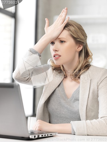 Image of stressed woman with laptop computer