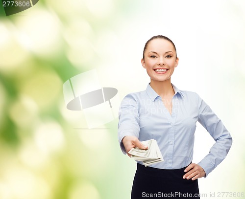 Image of young businesswoman with dollar cash money