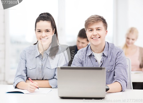 Image of students with laptop and notebooks at school