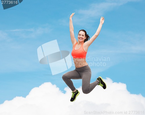 Image of sporty teenage girl jumping in sportswear