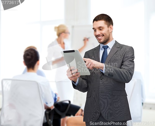 Image of smiling buisnessman with tablet pc computer