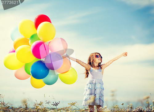 Image of happy girl with colorful balloons