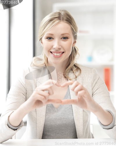Image of young woman showing heart sign