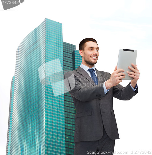 Image of smiling businessman with tablet pc computer