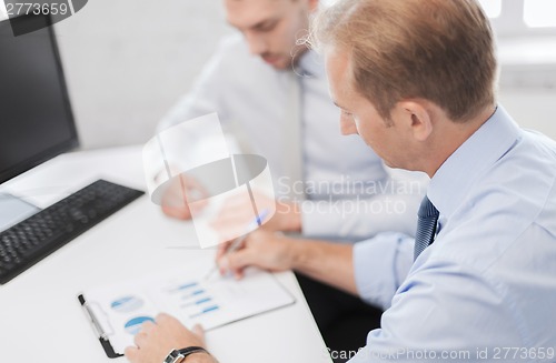 Image of businessmen with notebook on meeting