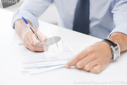 Image of man signing a contract