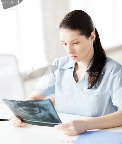 Image of doctor or dentist looking at x-ray