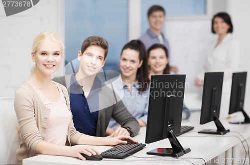 Image of students with computer monitor at school