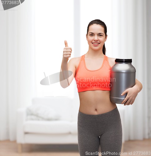 Image of teenage girl with jar of protein showing thumbs up