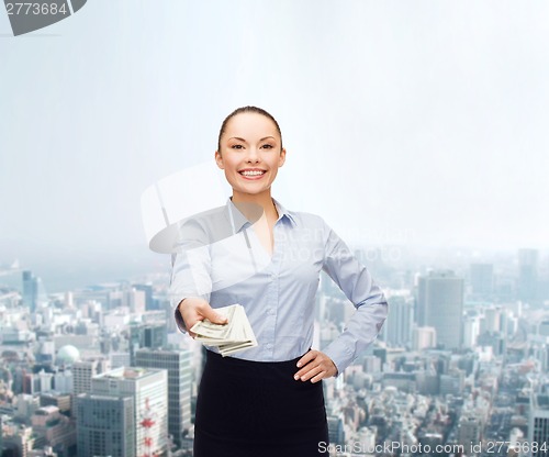 Image of young businesswoman with dollar cash money