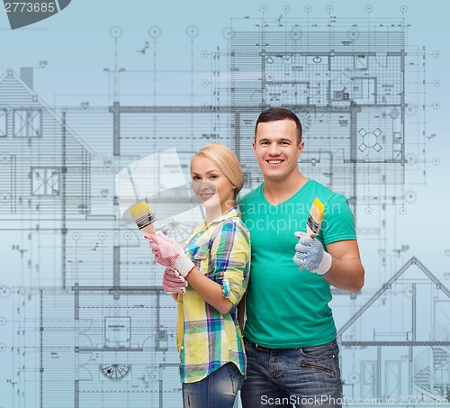 Image of smiling couple with paintbrush