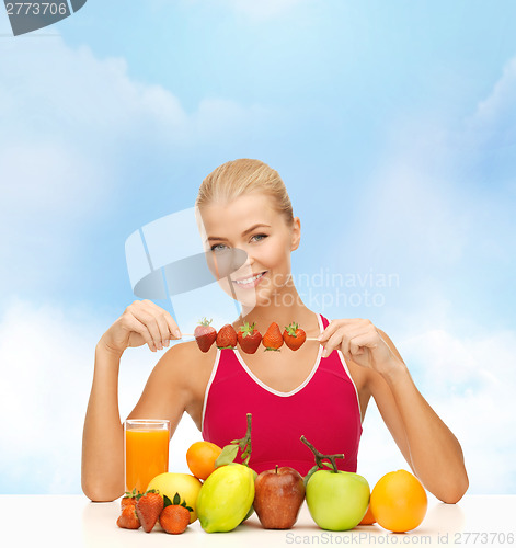 Image of smiling young woman with organic food on the table