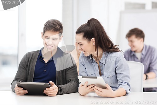 Image of students looking at tablet pc in lecture at school