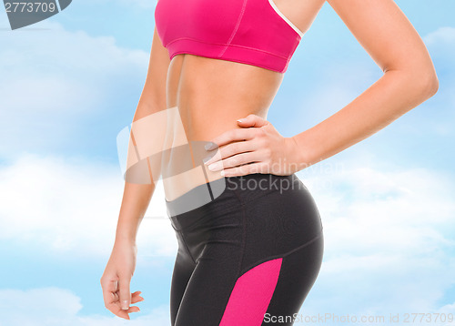 Image of close up of female abs in sportswear