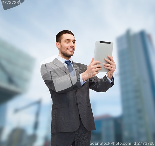 Image of smiling buisnessman with tablet pc computer