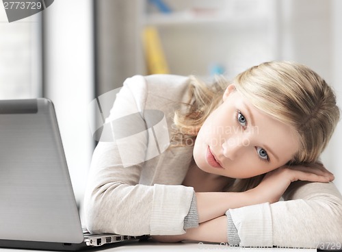 Image of tired woman with laptop computer