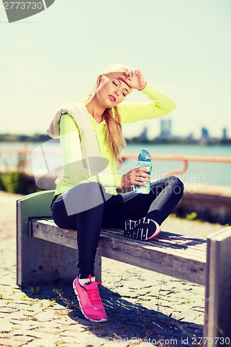 Image of woman resting after doing sports outdoors