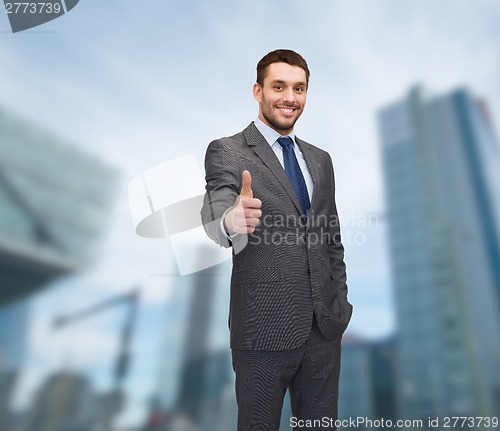 Image of handsome buisnessman showing thumbs up