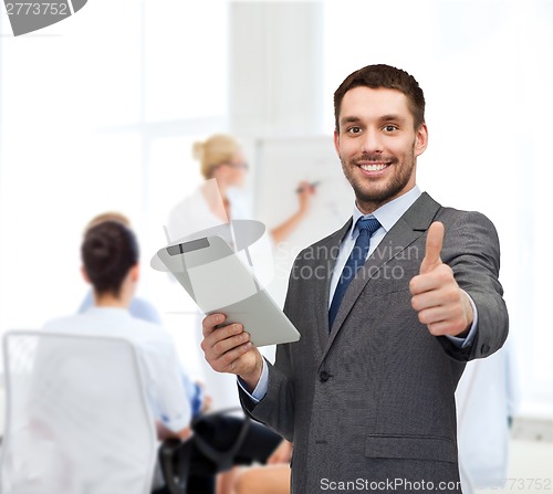 Image of smiling buisnessman with tablet pc computer