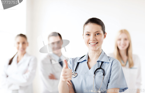 Image of doctor with group of medics showing thumbs up