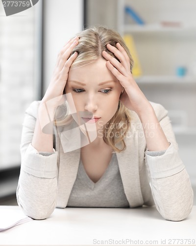 Image of unhappy woman in office