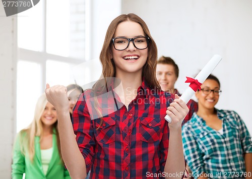 Image of smiling female student in eyeglasses with diploma