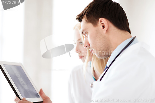 Image of two doctors looking at x-ray on tablet pc
